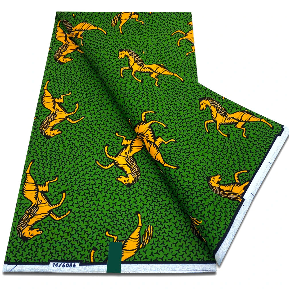 Green Ankara wax print fabric with orange leaping antelope motifs