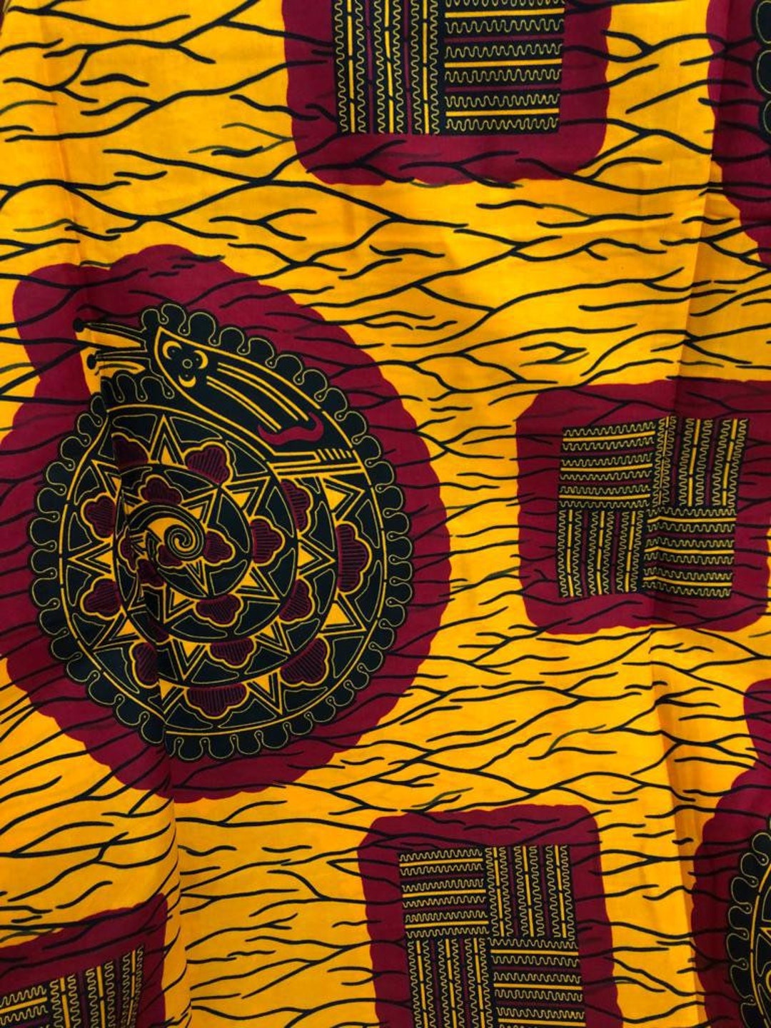 Close-up of yellow Ankara wax print with red medallions