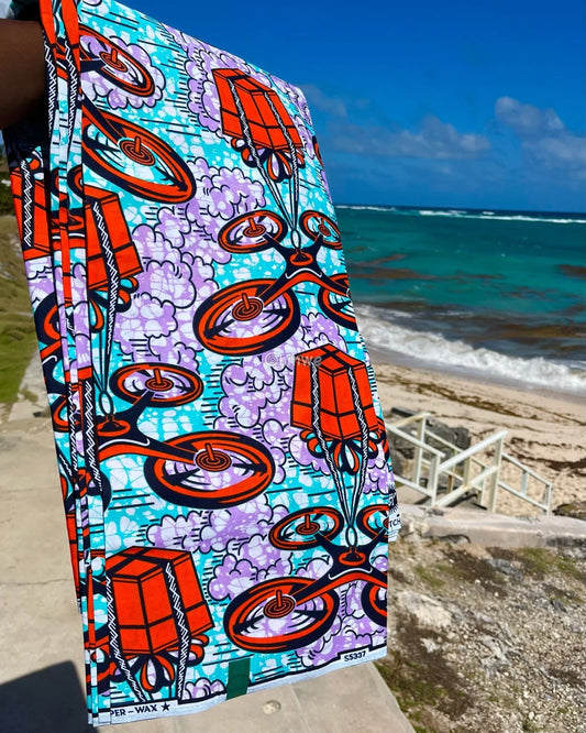African Wax Print with Red Parcel Drones and Lilac Smoke on Sky Blue Batik Ground Tech-Inspired Motif Lavender Drone