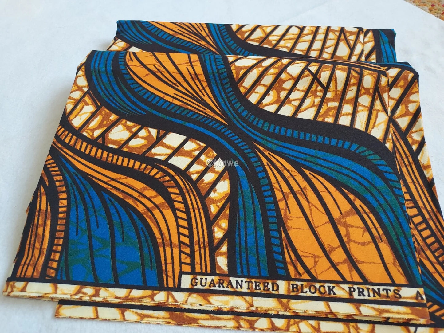 Blue and Orange Ankara Wax Print Fabric with Abstract Flowing Lines