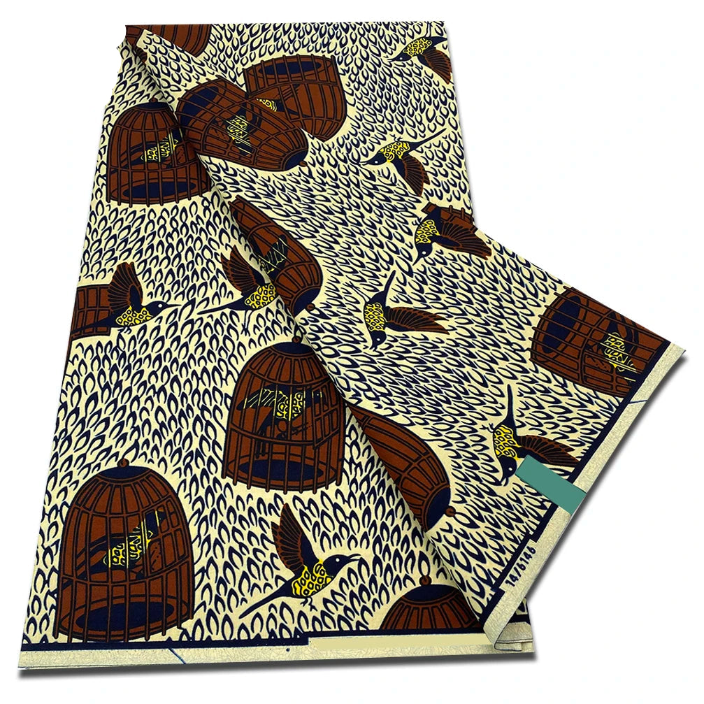 Cream Ankara wax print fabric with brown birdcages and birds on navy speckle