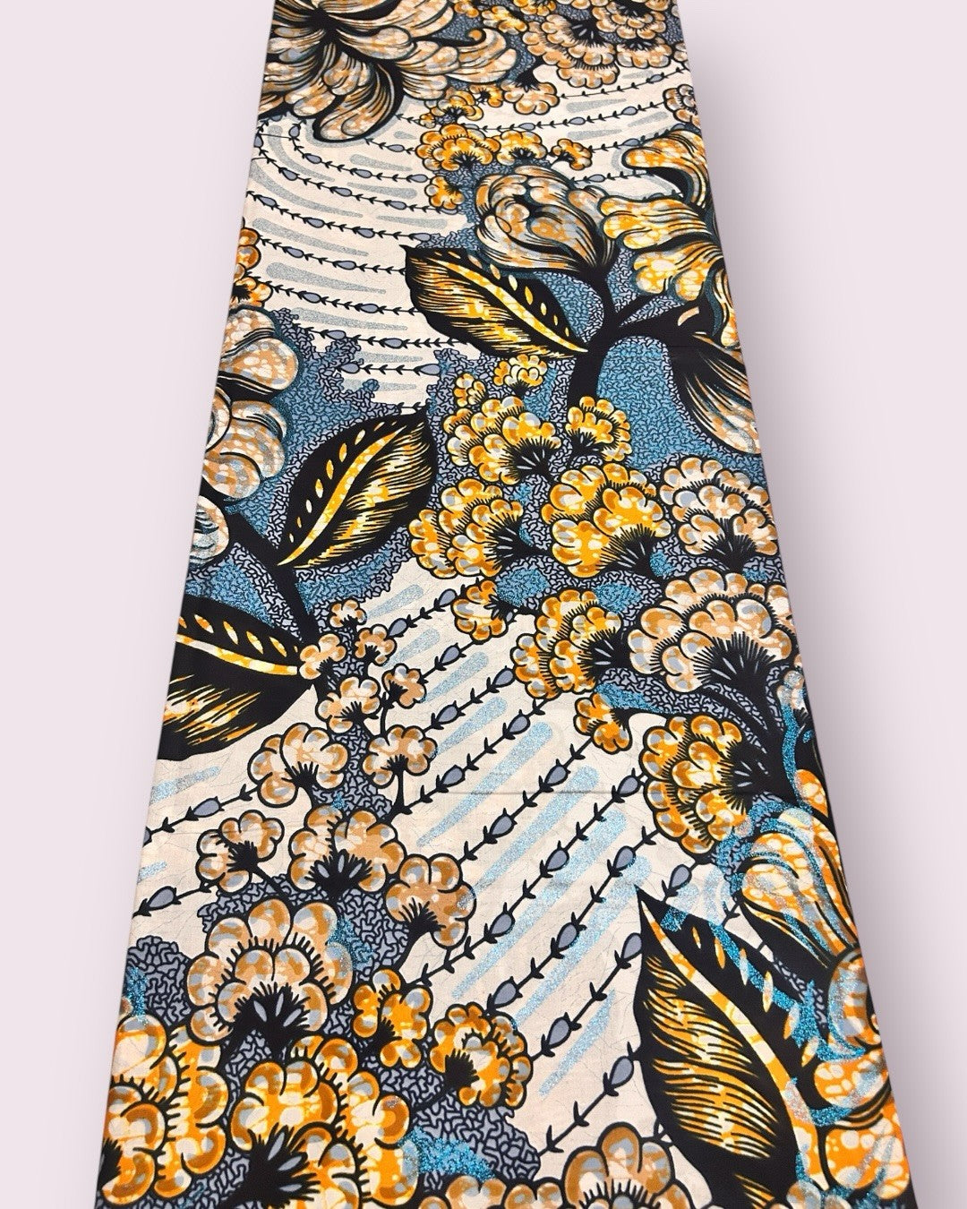 Blue and bronze bloom golden wax fabric laid out