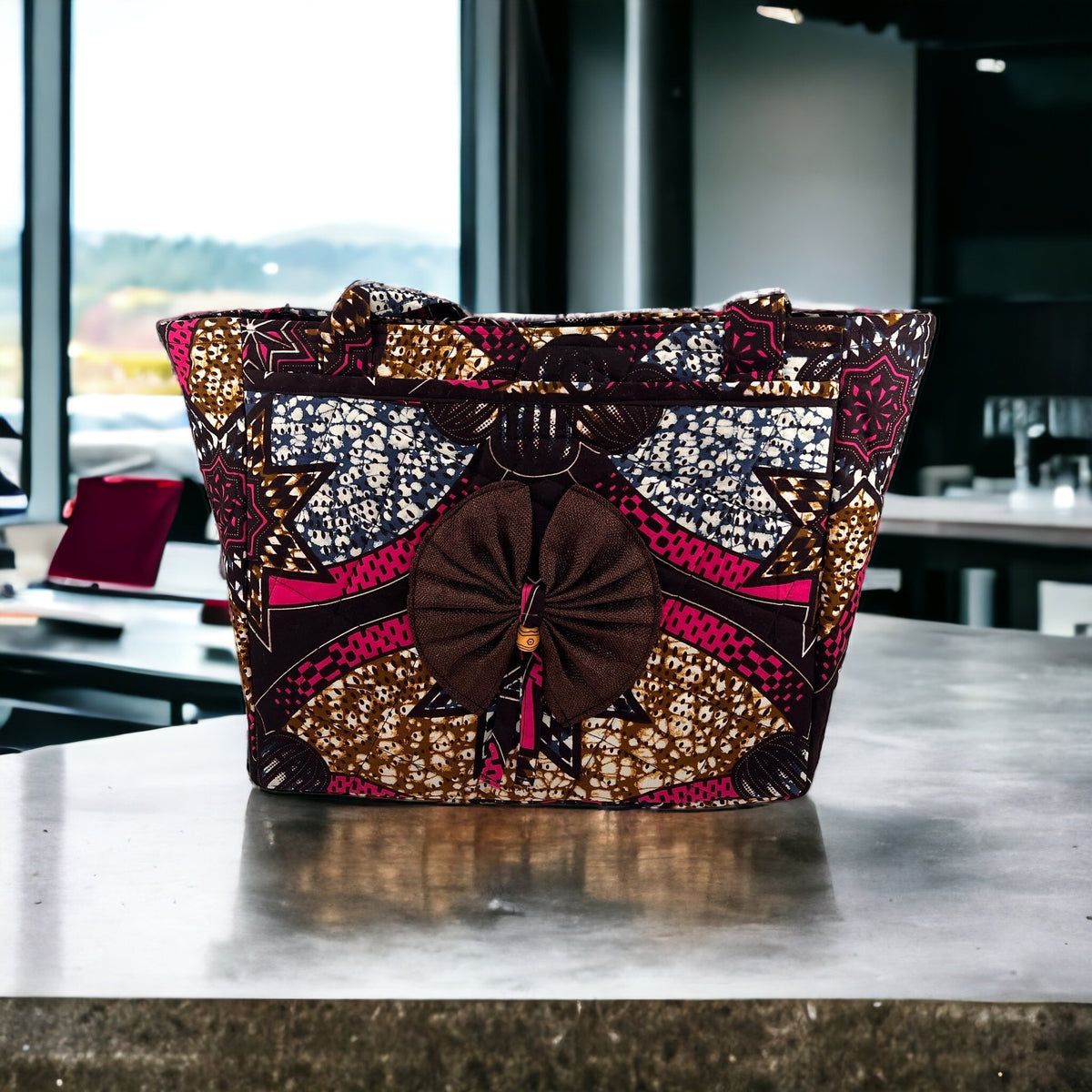 Review image: a structured African-print tote bag with a large fabric bow.