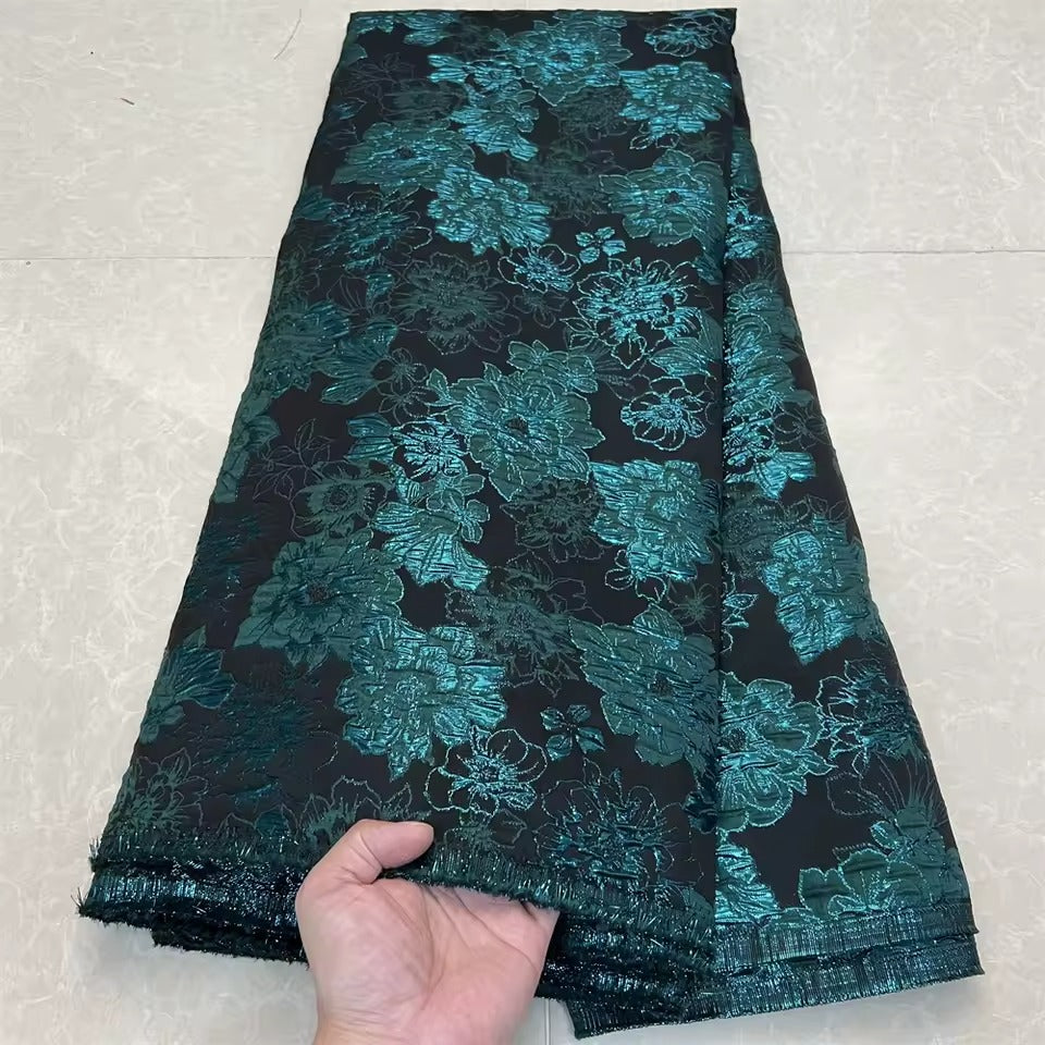 Metallic jacquard damask with raised floral pattern and gilded finish embroidered on tulle base