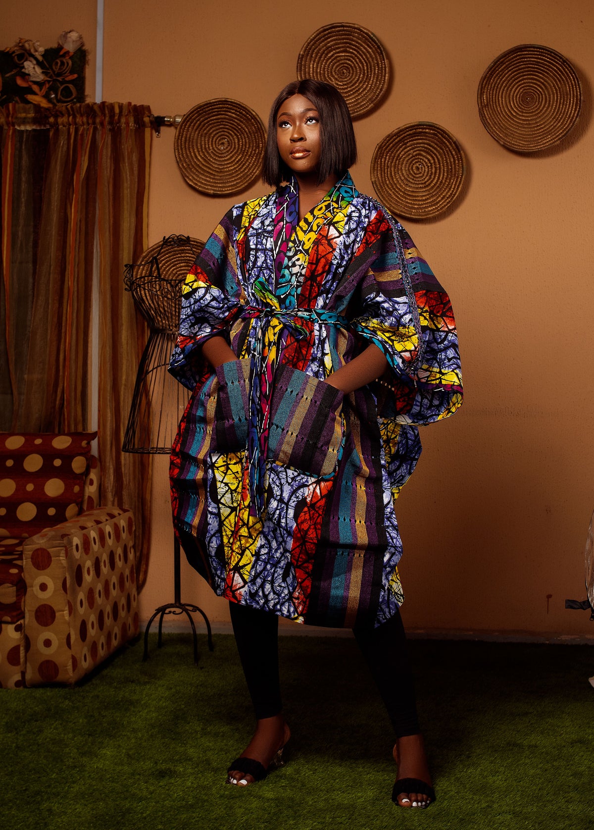 A model in a colorful printed robe, photographed by Alpha Paul.