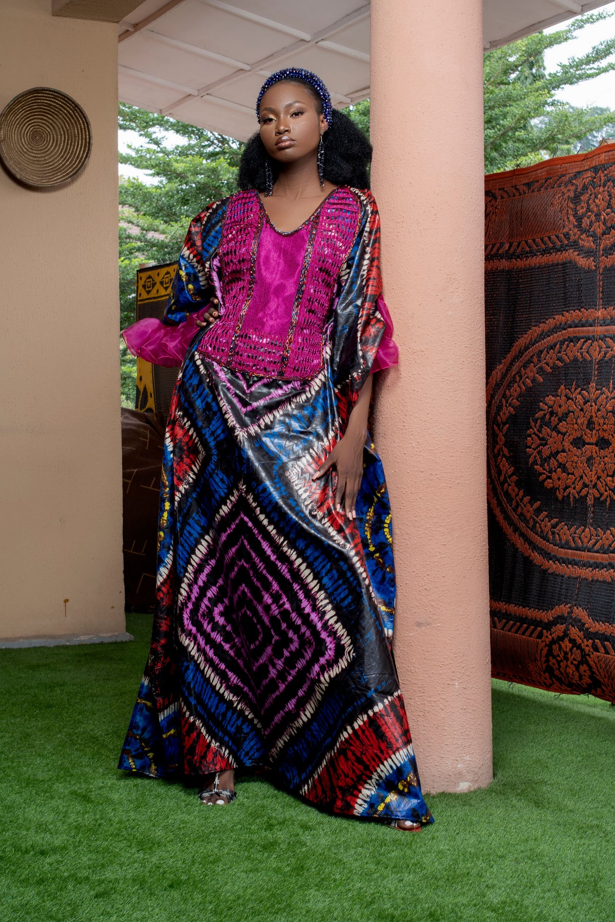 Fashion inspiration: a model wearing a long patterned dress with a magenta neckline.